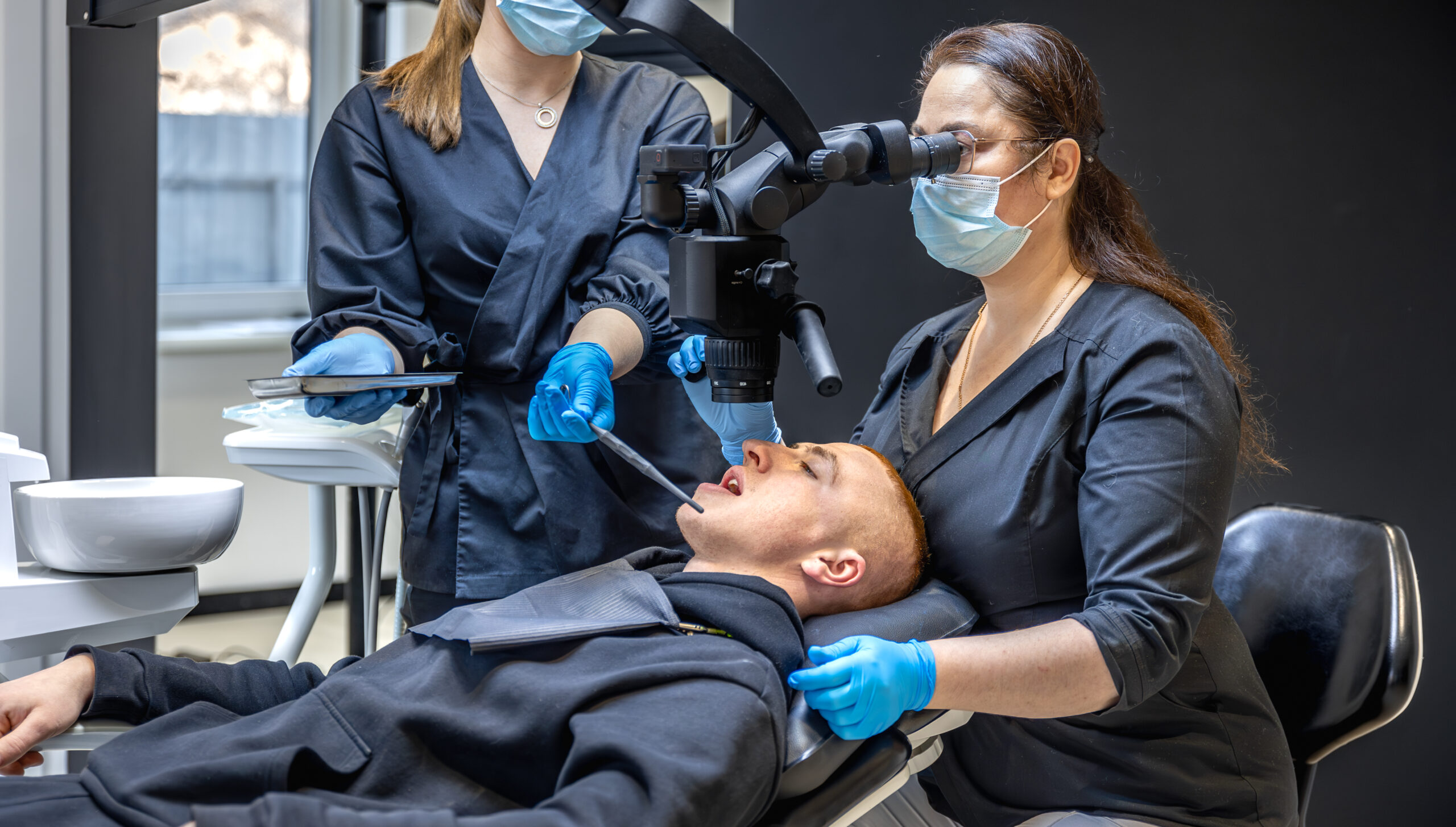 Dental team treating a patient with modern equipment